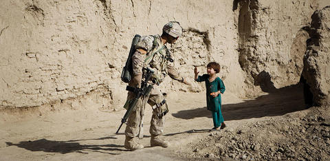 Soldier giving a child a high five